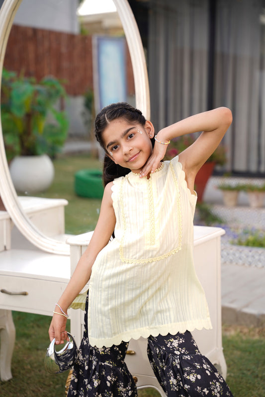 Full front, standing outdoors: "lemon lawn sleeveless shirt with dark floral printed gharara, full front view SHAFAÉ lemon Bloom"