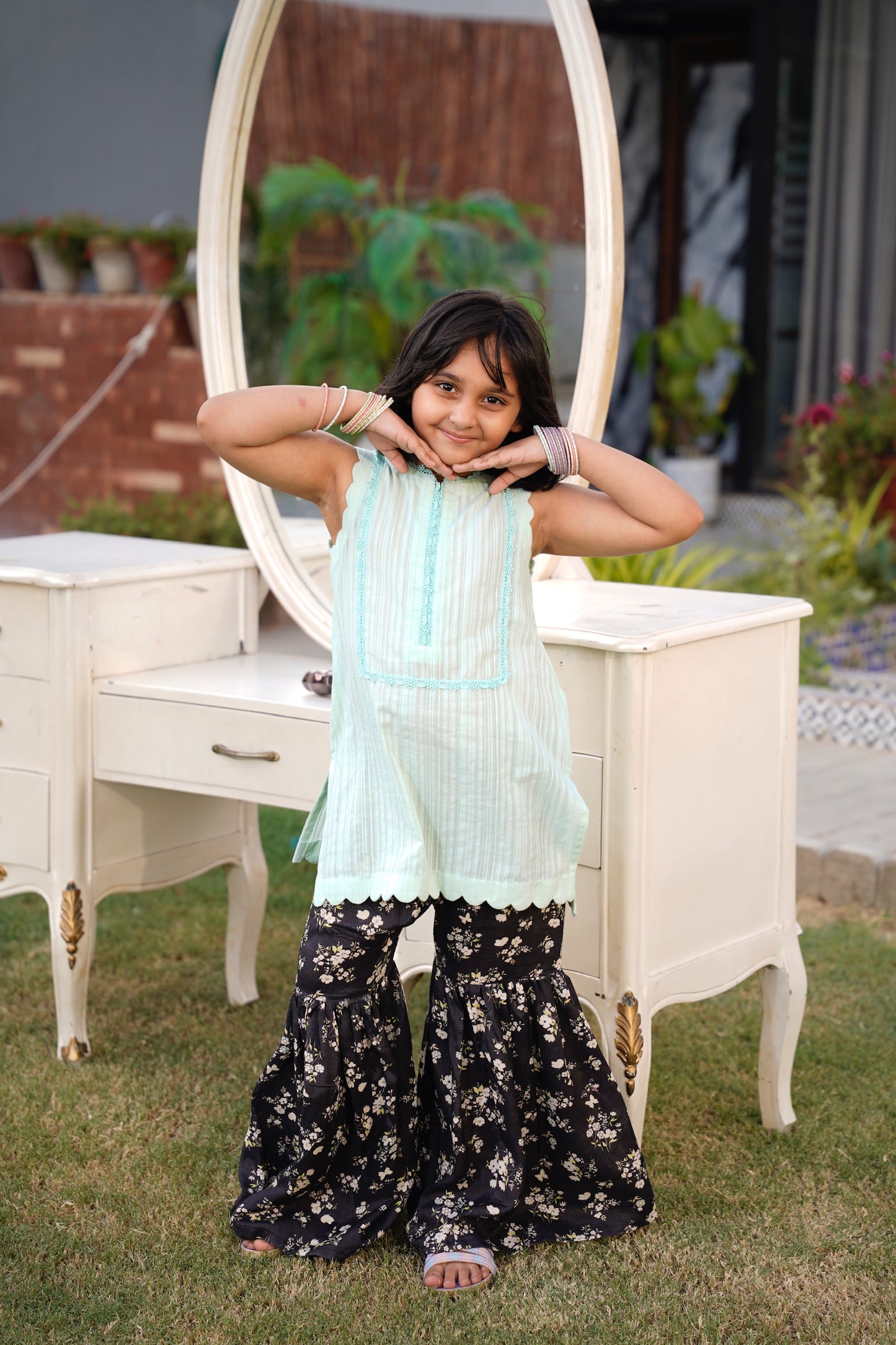 Full front, standing outdoors: "Mint lawn sleeveless shirt with dark floral printed gharara, full front view SHAFAÉ Mint Bloom"