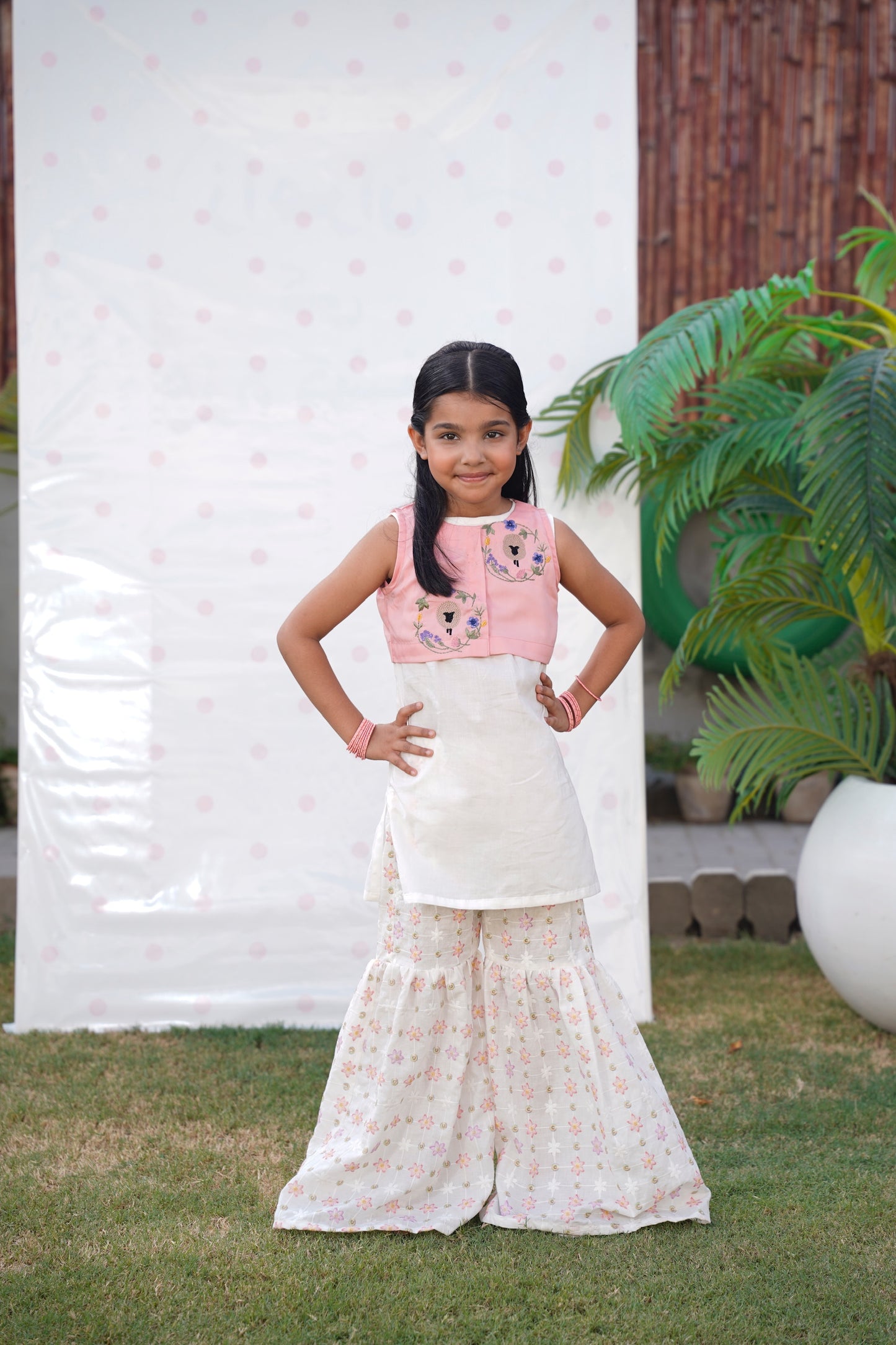 Full front, standing outdoors: "Blush pink embroidered cotton koti with floral chikankari gharara, full front view  SHAFAÉ Goatie Blush"