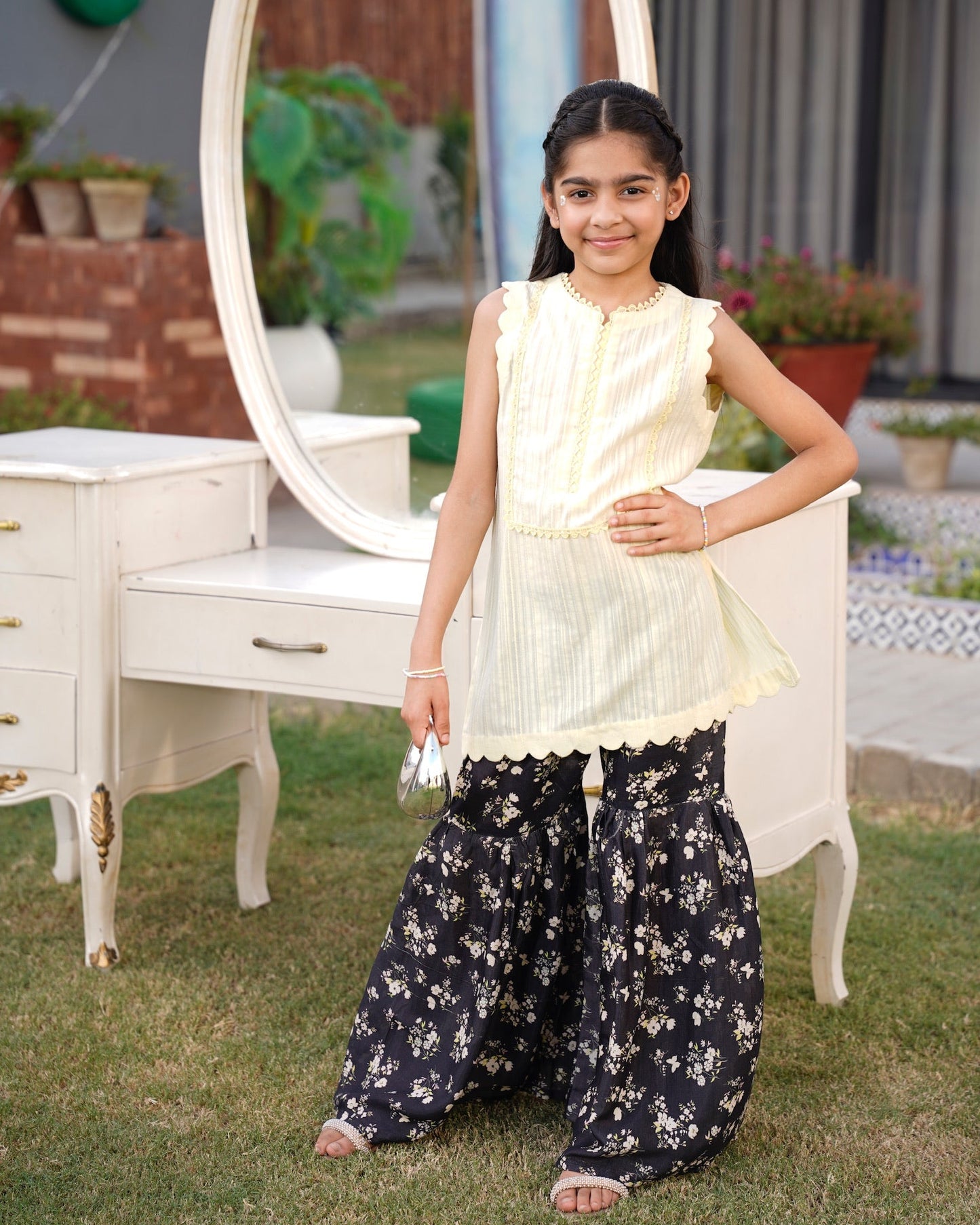 Full front, standing outdoors: "lemon lawn sleeveless shirt with dark floral printed gharara, full front view SHAFAÉ lemon Bloom"