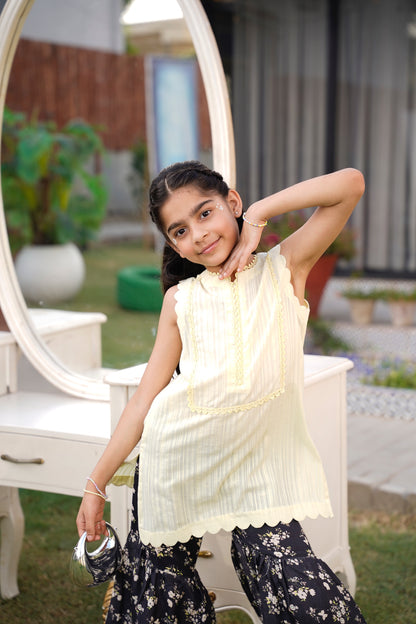 Full front, standing outdoors: "lemon lawn sleeveless shirt with dark floral printed gharara, full front view SHAFAÉ lemon Bloom"