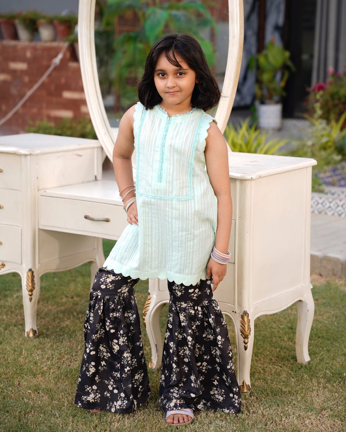 Full front, standing outdoors: "Mint lawn sleeveless shirt with dark floral printed gharara, full front view SHAFAÉ Mint Bloom"