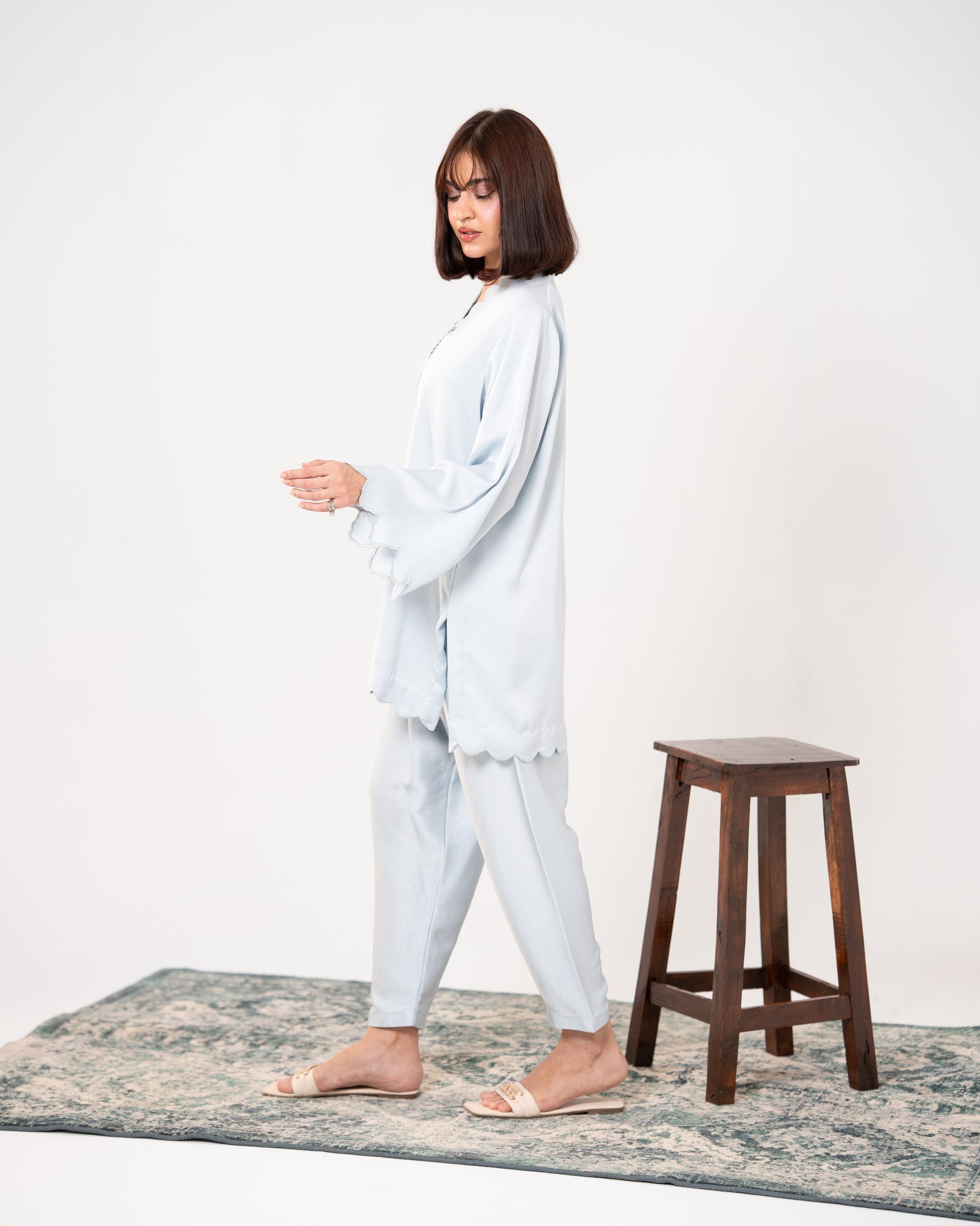 "Side view of ice blue silk co-ord with tiered scalloped bell sleeves — SHAFAÉ Ice Blue Embroidered Co-Ord"
