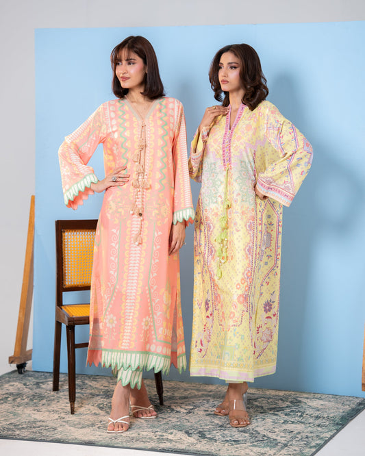  "two woman standing in Peach printed silk kaftan with scalloped mint trim and pastel yellow printed kaftan, side view SHAFAÉ Peach Maze"