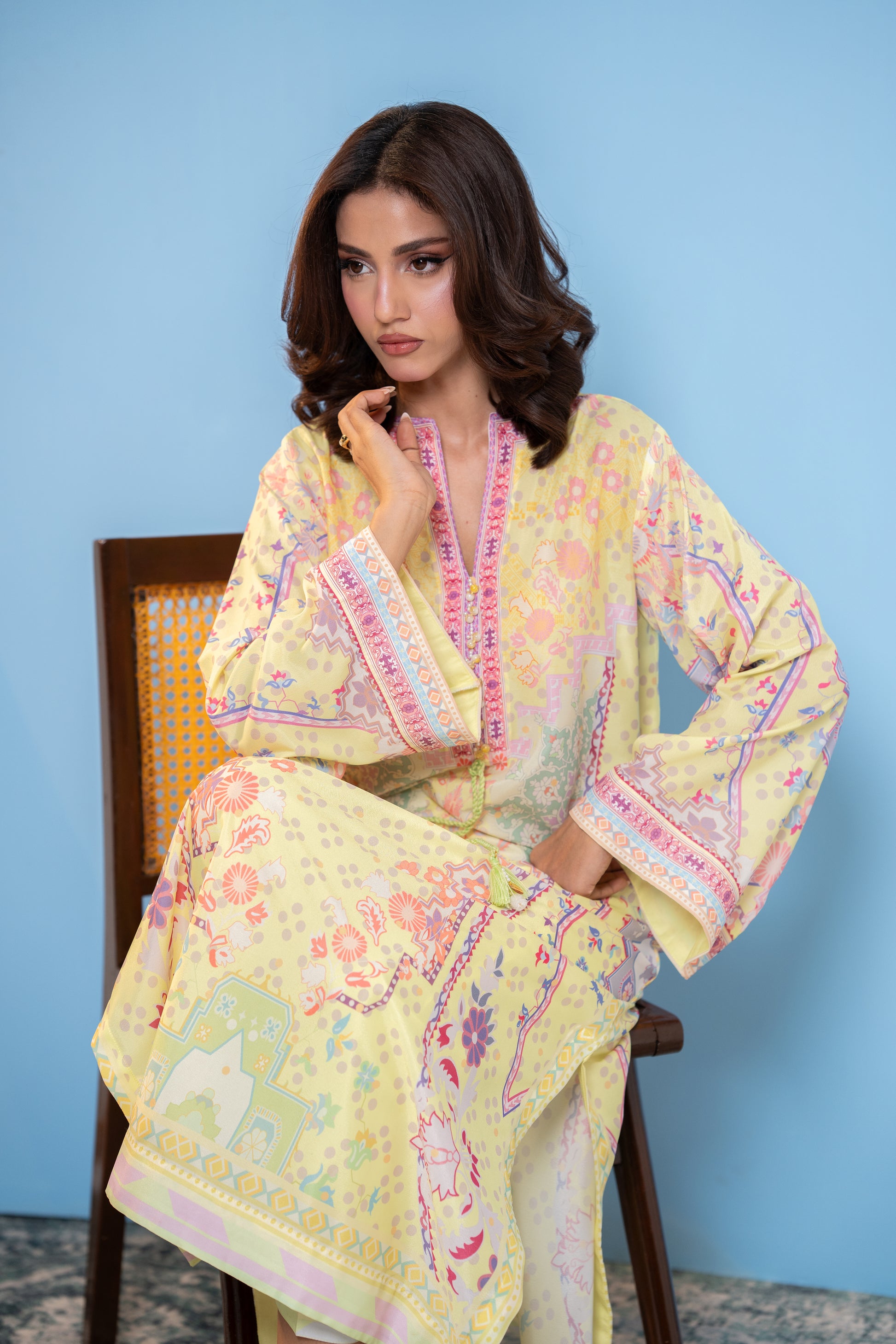 "Pastel yellow printed silk kaftan, seated front view  SHAFAÉ Sunlit Kaftan"