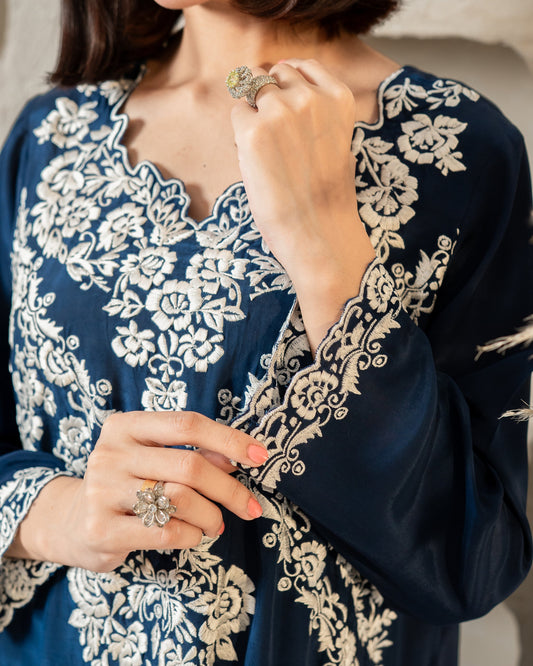 "Close-up of ivory floral embroidery on navy silk neckline SHAFAÉ Royal Blue Elegance"