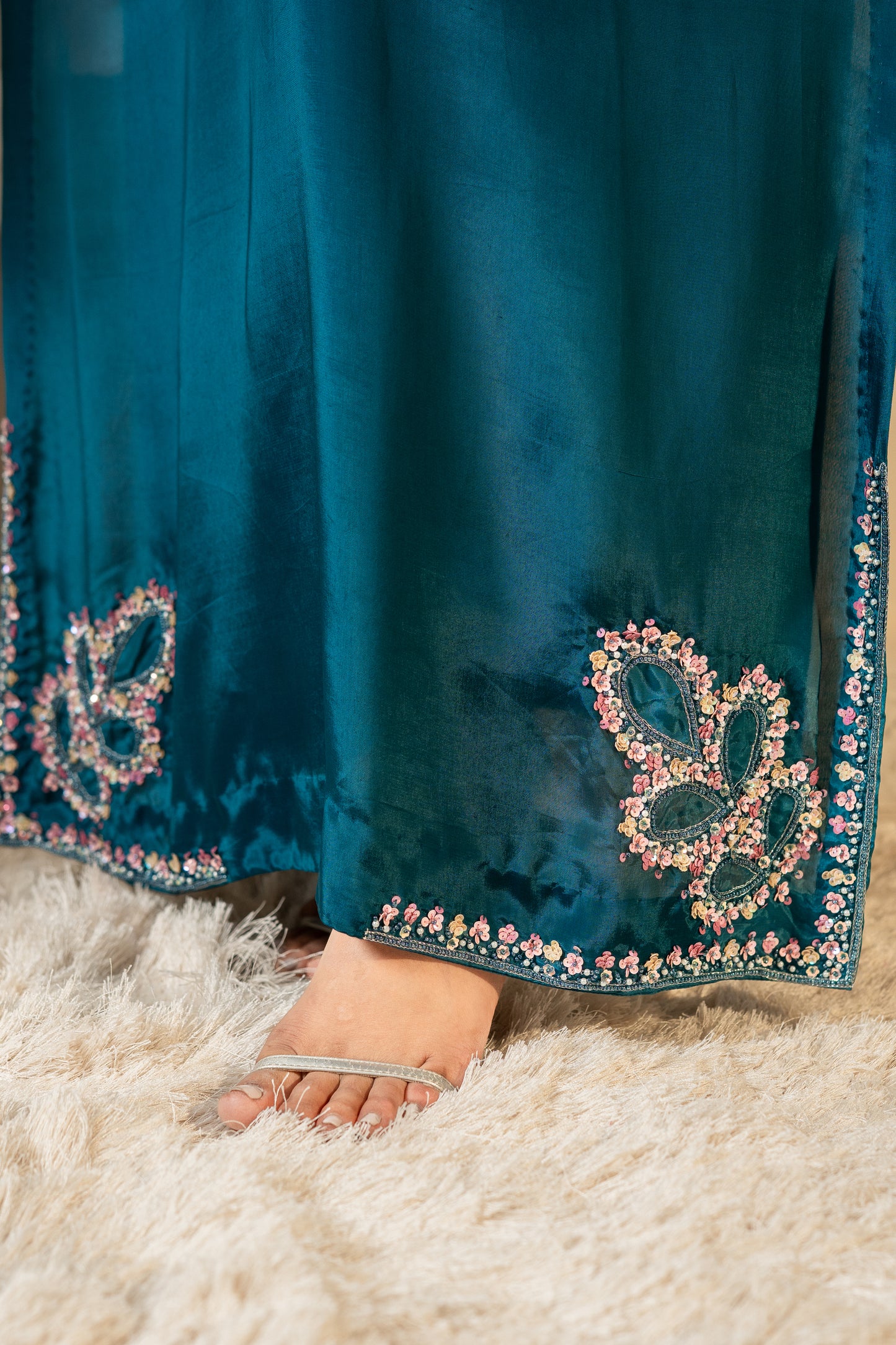 Close-up of a  floral embroidery Teal silk kaftan with embellished hemline SHAFAÉ Stardust Teal Kaftan"