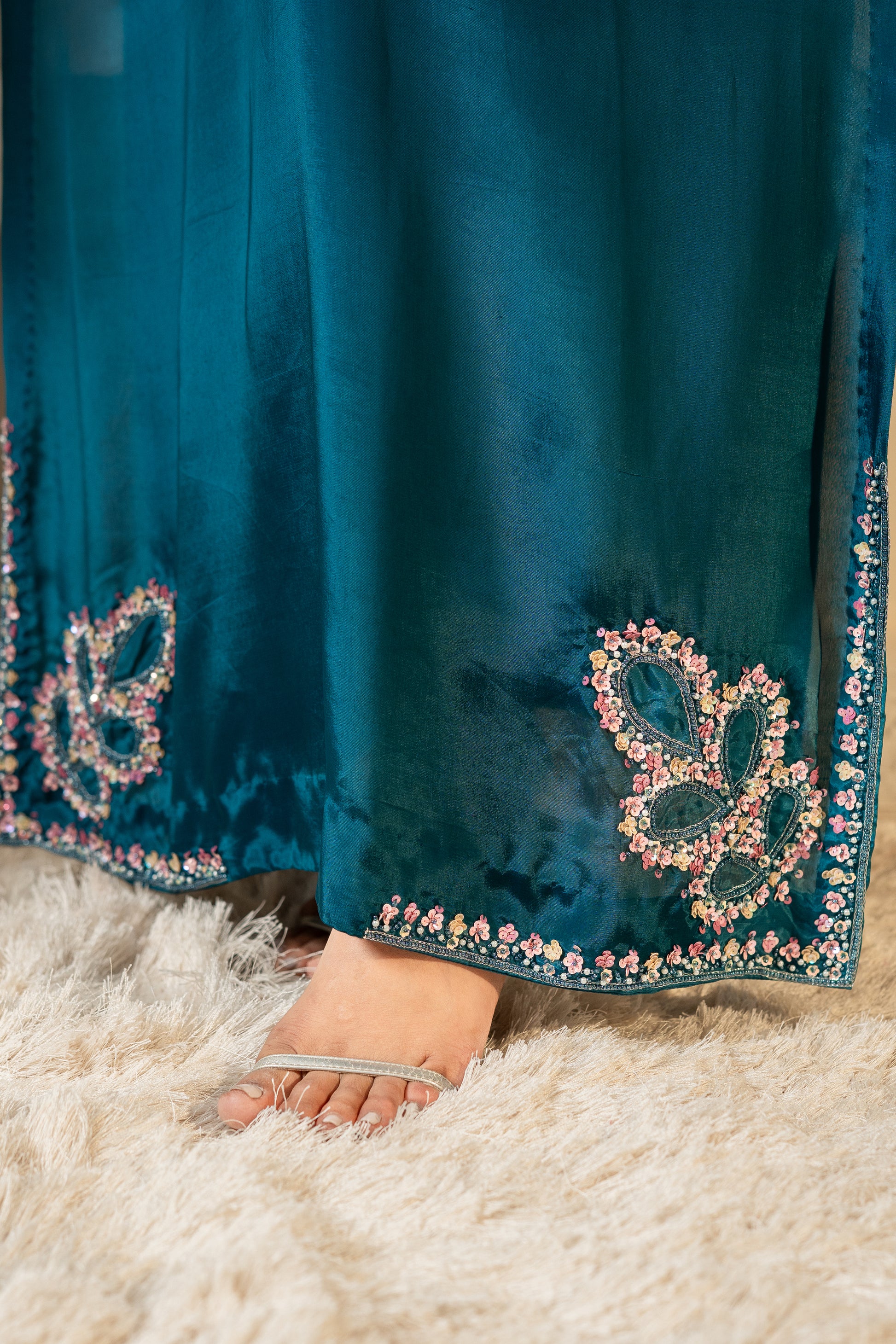 Close-up of a  floral embroidery Teal silk kaftan with embellished hemline SHAFAÉ Stardust Teal Kaftan"