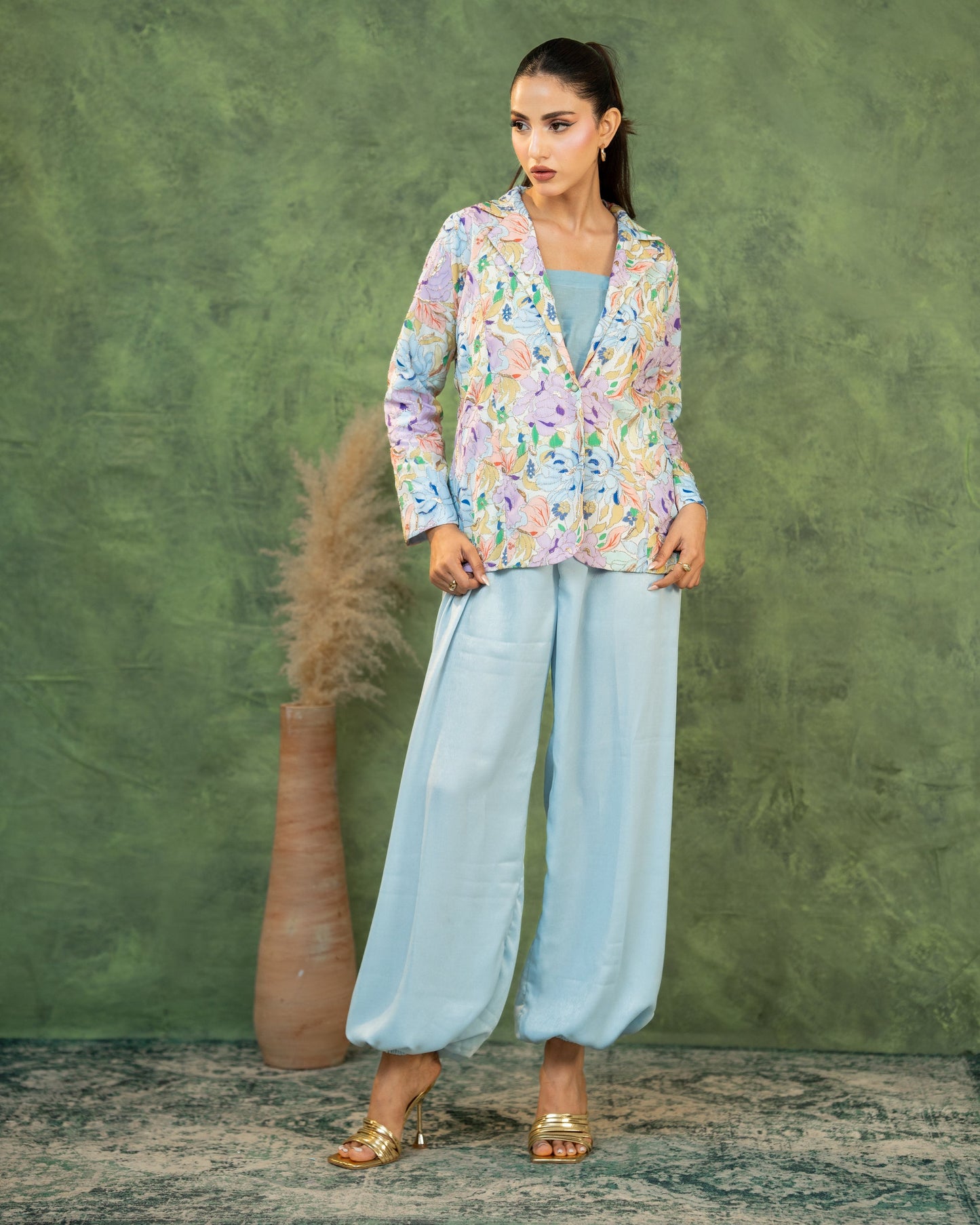 Close-up, adjusting blazer: "Close-up of pastel sky blue floral printed blazer  co-ord set — SHAFAÉ