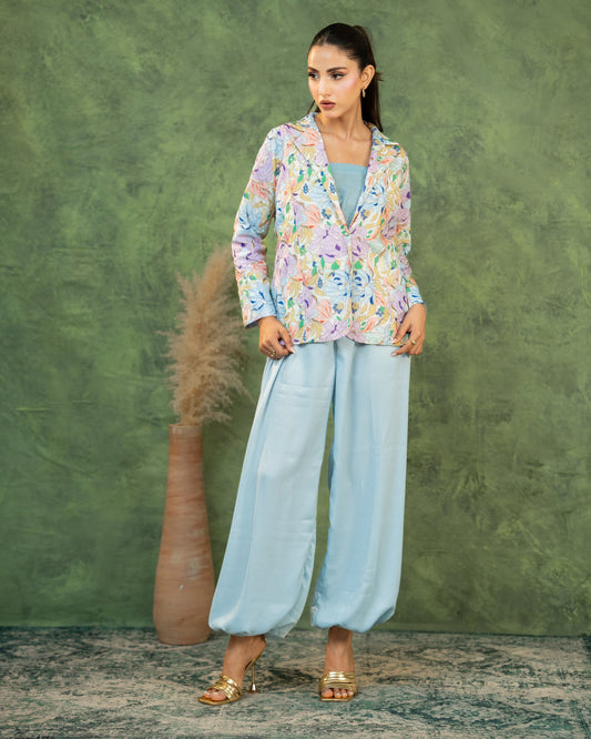 Close-up, adjusting blazer: "Close-up of pastel sky blue floral printed blazer  co-ord set — SHAFAÉ